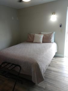 a bedroom with a large bed with a white comforter at Red Rock Motel in Page