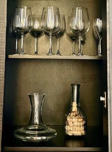 a group of wine glasses sitting on a shelf at Duplex Toledo Catedral con parking gratis in Toledo