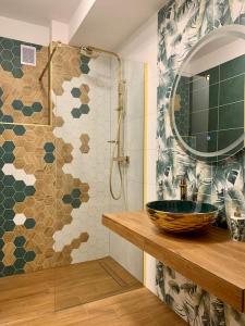 een badkamer met een wastafel en een douche met een spiegel bij Brand New, Design Apartment JoJo, OldTown, Balcony in Bratislava