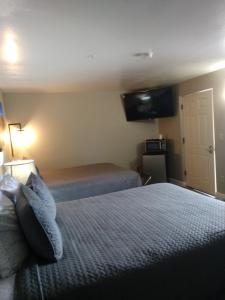 a hotel room with a bed and a door at Red Rock Motel in Page