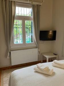 a bedroom with a bed with two white towels on it at Anavros beach house in Volos