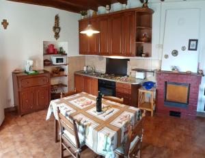a kitchen with a table and a stove top oven at Rustico Vita in Rezzonico