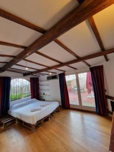 a bedroom with a large bed in a room with wooden floors at ELEGANT ROOMS PARIOLI in Rome