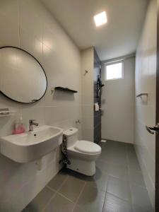 a bathroom with a sink and a toilet and a mirror at Novo 8 2-Bedrooms Condo Extreme City View Suite in Melaka