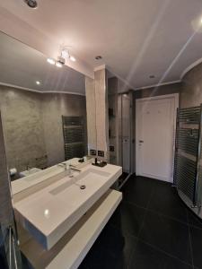 a large bathroom with two sinks and a large mirror at ELEGANT ROOMS PARIOLI in Rome