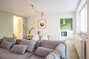 a living room with a couch and a table at Gîtes in Huy - Appartements chaleureux dans le centre de Huy in Huy