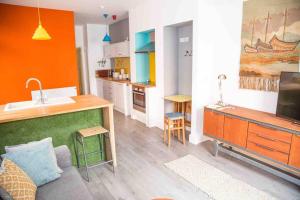 a living room with a sink and a kitchen at Chequer - seafront 1 bed ground floor garden flat in Cleethorpes