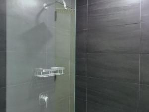 a bathroom with a shower with a glass door at Penthouse , 1BR , Loft , WIFI up to 100mbps , Cozy in Cebu City +46 photos