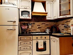 a kitchen with white cabinets and a white refrigerator at Chata Vysočina in Svratouch