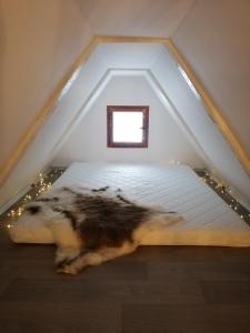 a bed in the attic with lights on it at Chata Vysočina in Svratouch