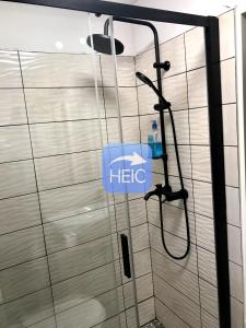 a shower with a htec sign in a bathroom at Chata u Chrobáčků na Čeladné in Čeladná