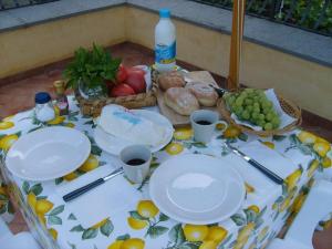 a table with plates of food and fruit on it at Casa Iolanda in Sorrento