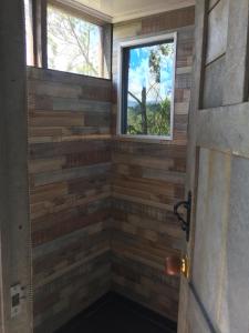 a shower in a tiny house with a window at PrivaDome in Rionegro
