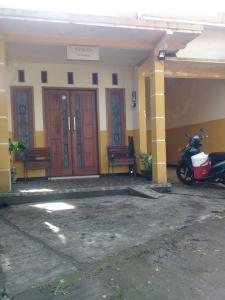 a motorcycle parked in front of a building at Azalea Homestay in Batu