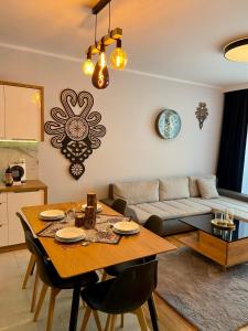 a living room with a table and a couch at Górski Apartament Olimpijska 1L in Szczyrk