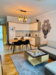 een woonkamer met een bank en een tafel bij Górski Apartament Olimpijska 1L in Szczyrk