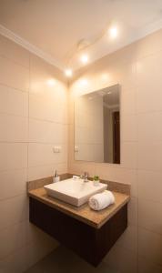 a bathroom with a sink and a mirror at Riverfront II, piso 2, suite vista al rio, Puerto Santa Ana, Guayaquil in Guayaquil