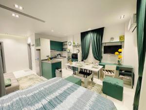 a bedroom with a bed and a kitchen with a table at Luxury Studio House 589-1 in 6th Of October +3 photos