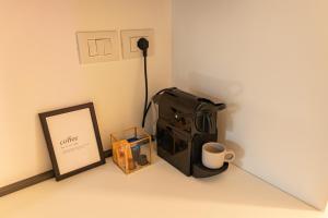 a corner of a room with a suitcase and a picture at BF Glam-Apartments in Perugia