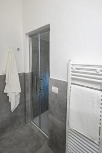 a shower with a glass door in a bathroom at BF Glam-Apartments in Perugia
