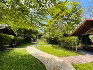 a stone path in a yard with a house at Phayam Valley Homestay in Ko Phayam