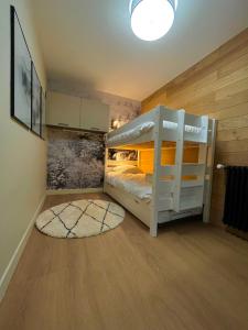 - une chambre avec des lits superposés et un tapis dans l'établissement IMMOGROOM - Total renovation 2023 - At the foot of the slopes - Wifi -, à Tignes