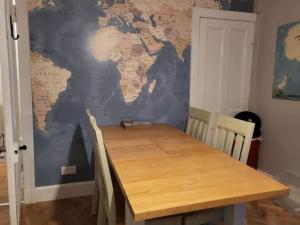 a dining room with a table and a world map on the wall at Georgian townhouse in centre of Perth in Perth