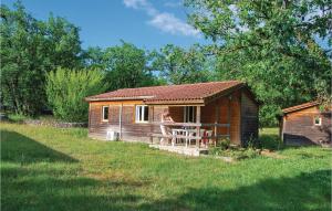 a woman sitting on the porch of a cabin at Les Sgalires in Gramat