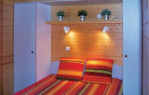 two colorful pillows sitting on a bed in a room at Les Sgalires in Gramat