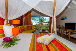 a bedroom with a bed with towels on it at PALM COURT RESIDENCE 4 Stars in Orient Bay