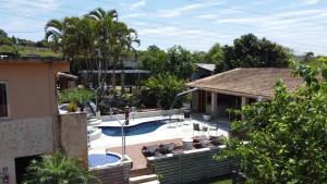 a house with a swimming pool in a yard at Pousada Villa São Francisco in Boituva
