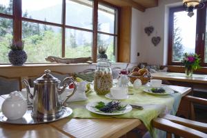 a table with a tea kettle and plates of food at Dreimäderlhaus am Berg in Pfronten