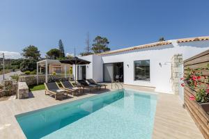 a swimming pool in front of a house at EVELAND ACCESSIBLE VILLAS in Sfakaki