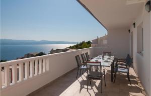 balcón con mesa, sillas y vistas al océano en Beautiful Apartment In Stanici With House Sea View en Celina