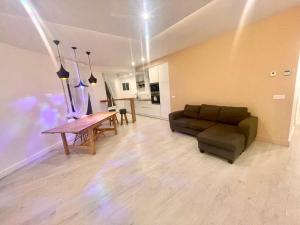 a living room with a couch and a table at Cozy Apartment Near Sagrada Familia in Barcelona