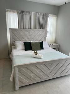 a bedroom with a large bed with a large headboard at New: Centric, City View, SofaBd in Santo Domingo