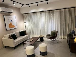a living room with a couch and a table and chairs at New: Centric, City View, SofaBd in Santo Domingo