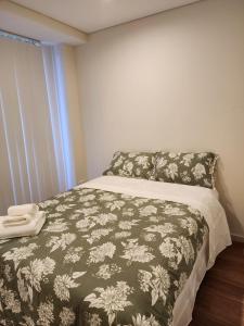 a bedroom with a bed with a blanket and a window at Shared Bright and Cozy Room in Parramatta CBD - close to everything in Sydney