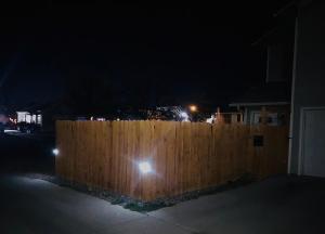 a wooden fence in front of a house at night at Cozy Studio in Grand Junction