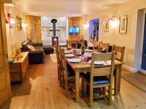 a dining room and living room with a table and chairs at Petham Hide in Petham