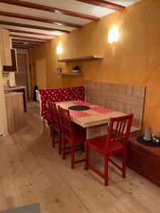 a kitchen with a table and chairs in a room at La Casa Bianca - ski, hike & bike in Passo del Tonale