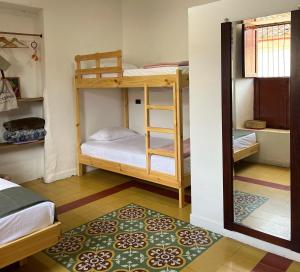 a room with two bunk beds and a rug at La Casona Espacio Bonito in Zapatoca