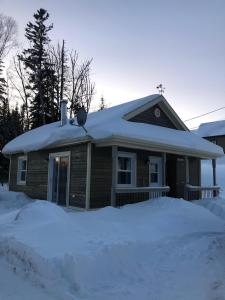 a house with snow on top of a pile of snow at Le Chal'heureux, ski & spa, ski-in ski-out in Val-Brillant