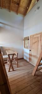 a room with a wooden table and a wooden door at Colibri - Cabañas Puerto del Zopilote in Pinal de Amoles