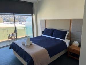 a bedroom with a large bed with a large window at Self contained in city with on site restaurant, gym & parking in Launceston