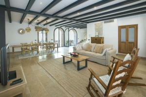 a living room with a couch and a table at Owl Booking Villa Alvarez - Luxury Retreat in Pollença