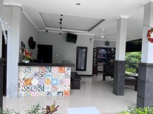 a lobby of a house with a colorful tile wall at Green Hill Inn in Jimbaran