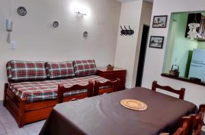 a living room with a table and a couch at Depto 2 amb Vista al Mar Aire Acond Wi Fi in Pinamar +5 photos