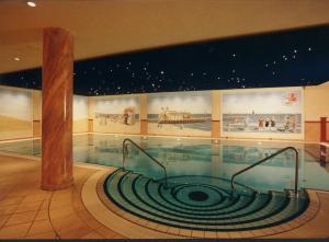 a swimming pool in the middle of a building at Usedom Palace in Zinnowitz