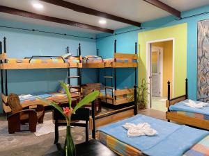 a room with four bunk beds and a table and chairs at Casa San Pablo B & B in San Pablo